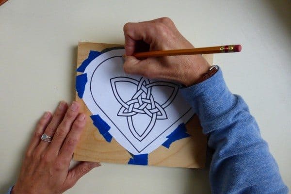 Trace the heart and the Celtic knot inside with a pencil to transfer the graphite design to the wood