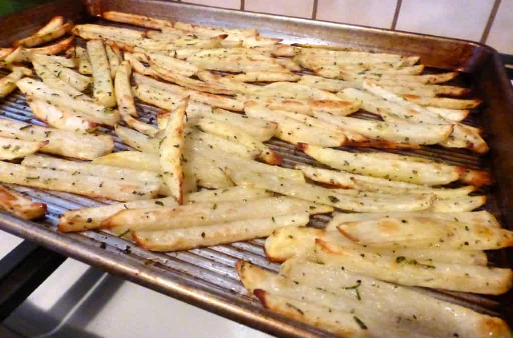 home-baked crispy golden french fries on tray just out of the oven looking tasty