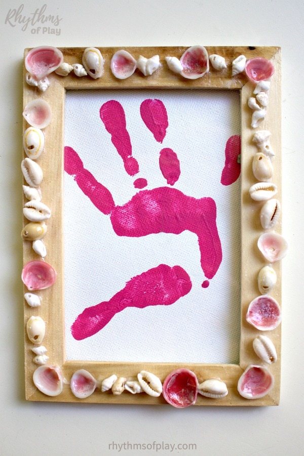 shell frame with handprint art placed inside the shell picture frame