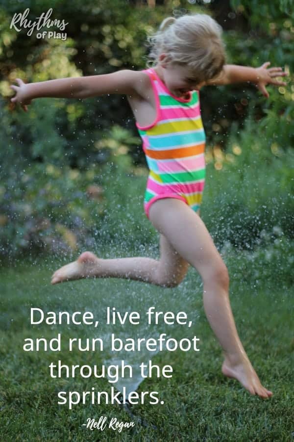 summer bucket list activity - child running barefoot through the sprinklers.