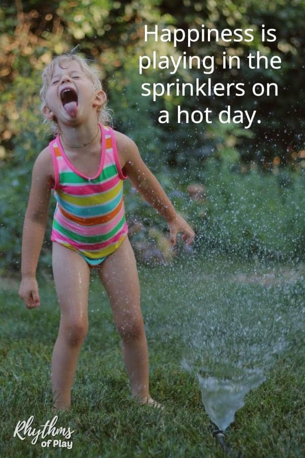 child playing in the sprinklers in the summertime.