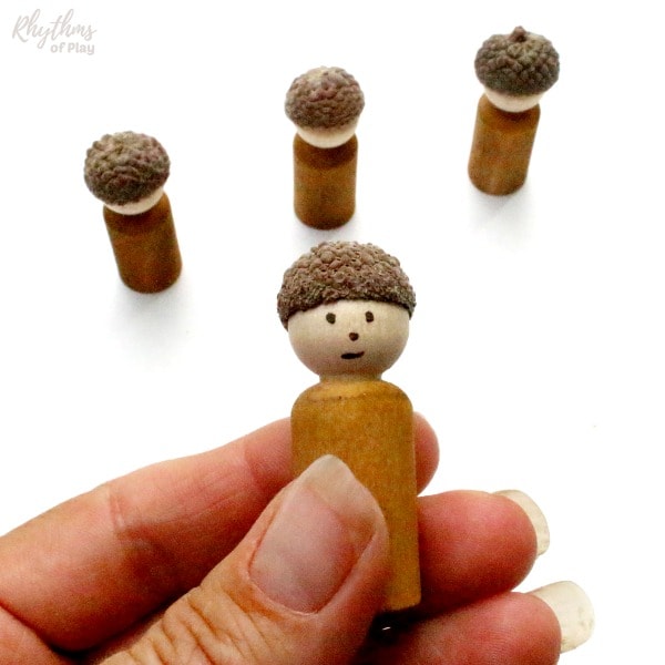Homemade wooden toy doll with an acorn cap.