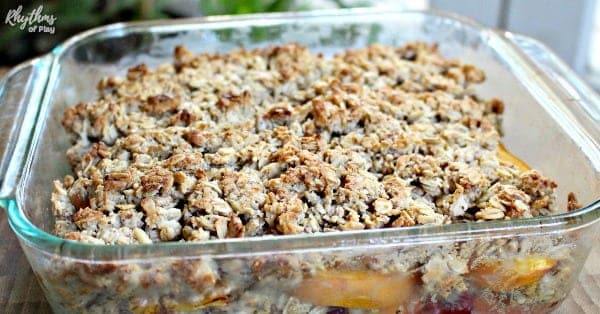 Gluten free cobbler recipe with peaches and raspberries in 9X9 baking dish.