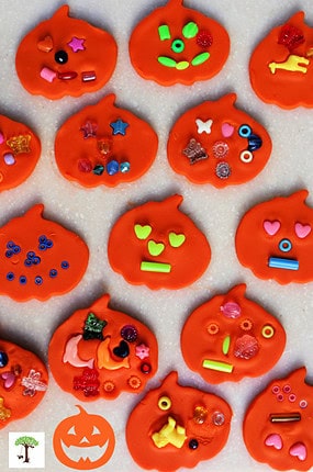 Several play dough Halloween pumpkin crafts decorated by toddlers and preschoolers