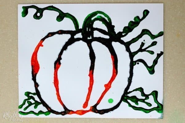 Here's how this harvest art project looks after painting the lines of salt before the pumpkin is painted orange