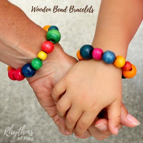 Mother and daughter wearing homemade wooden beaded bracelets and holding hands (bead bracelet crafts by and photos of Nell Regan K. and C. Kartychok)
