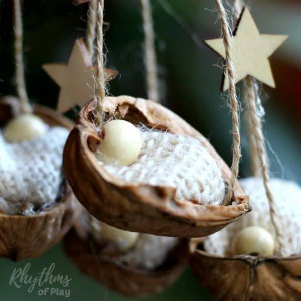 This DIY rustic homemade walnut shell manger Christmas ornament can be made by both kids and adults. Handmade ornaments like this kid-made baby Jesus in the manger are perfect for the Christmas tree. You can also use this craft as a part of a nativity scene. They make beautiful decorations and are a great keepsake gift idea! Click through for the easy to follow tutorial!