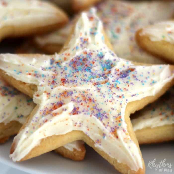 Cooking with kids is fun! First, use our easy cake mix sugar cookie recipe to make these super soft kindness cookies. Next, make some cream cheese icing. Then decorate with rainbow sprinkles and pass them out as a kindness service project with the kids. My daughter and I were inspired to make these cookies after reading "The Story of the Kindness Elves." Try this kids kitchen book activity and kindness project for kids today!