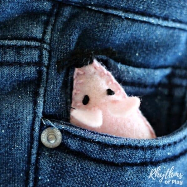 felt mouse toy pet peeking out of a child's pocket