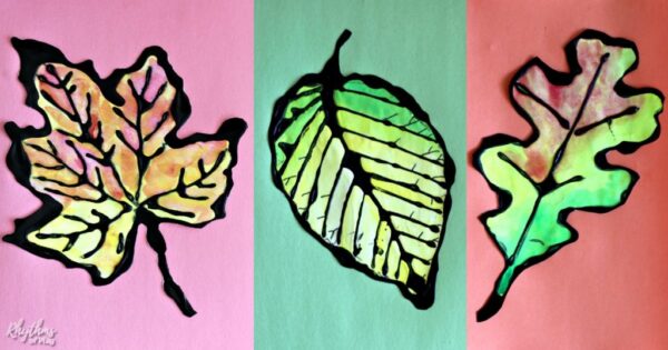 Maple leaf, beech leaf, and oak leaf art project with watercolors and black glue.