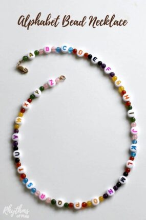 Alphabet bead necklace beginning jewelry craft for kids. A literacy and fine motor activity for children. String ABC beads to learn the alphabet and develop the fine motor muscles in the hand to prepare for writing. Makes a unique handmade DIY jewellery gift idea kids can make! #craft #necklace #literacy