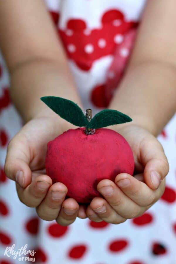 Apple craft for kids made with oak apples or oak balls.