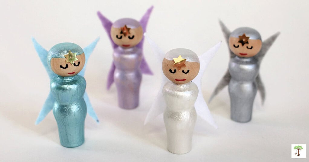 Winter peg dolls fairy crafts for kids and adults in snowy white, icy blue, frosty lavender, and silver gray.