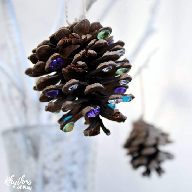 Add a little rustic bling to your Christmas tree with DIY rhinestone pinecone ornaments! An easy kid-made book-inspired Christmas nature craft kids and adults both enjoy crafting for the holidays.