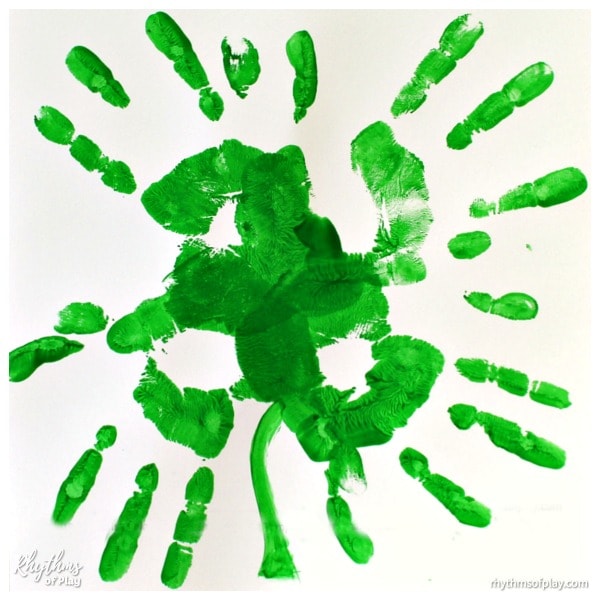 St. Patrick's Day handprint art in the shape of a four-leaf clover (art by Charlize Kartychok, photograph by Nell Regan K. co-founders of Rhythms of Play)