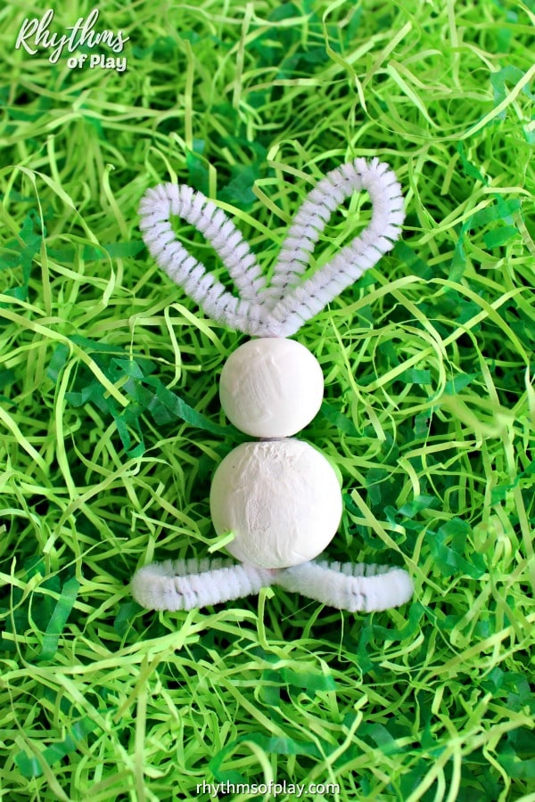 white bunny craft in Easter grass (Original bunny craft and photosby c. Kartychok and Nell Regan K. co-founders of Rhythms of Play)