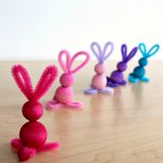 Multi-colored bunny crafts made with pipe cleaners and dyed colored wooden beads by Nell Regan and Charlize Kartychok co-founders of Rhythms of Play