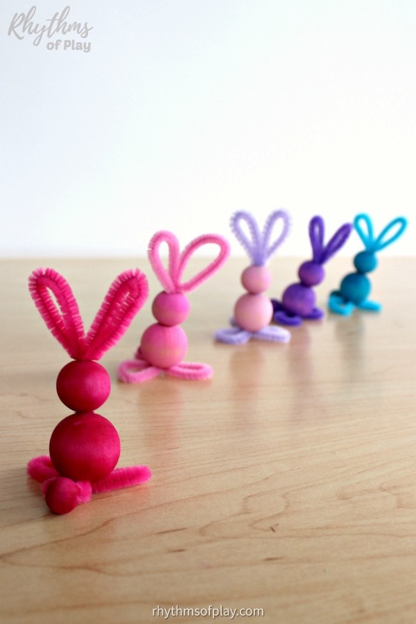 Multi-colored bunny crafts made with pipe cleaners and dyed colored wooden beads by Nell Regan and Charlize Kartychok co-founders of Rhythms of Play