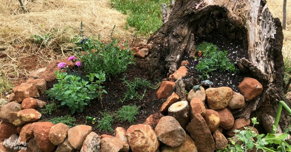 fairy garden tree stump with stacked stone container