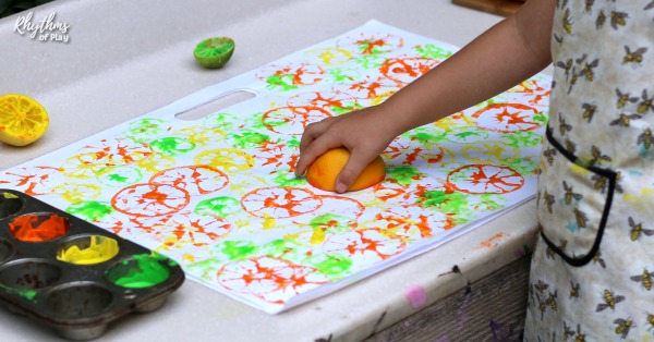 child making citrus prints with an orange, lemon and lime