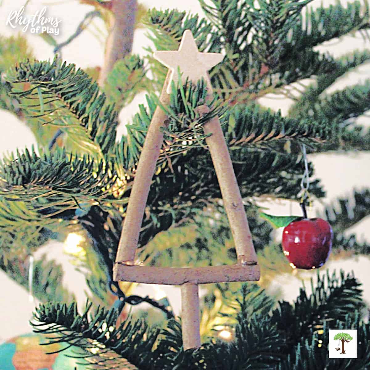 Christmas tree twig ornament hanging on the branch of a Christmas tree