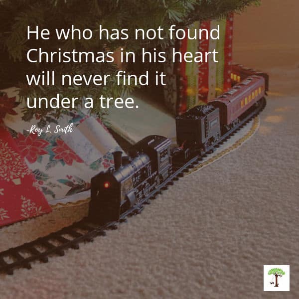 Christmas train under tree tradition with quote, "He who has not found Christmas in his heart will never find it under a tree."