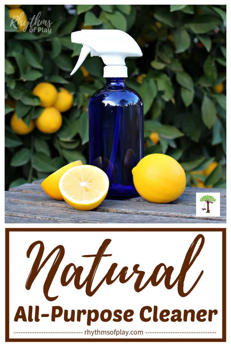 Natural DIY All-Purpose cleaner and disinfectant recipe for household cleaning in blue bottle on table with lemons