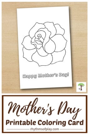 printable Mother's Day Coloring Card with Rose Outline folded in half on a wooden table.