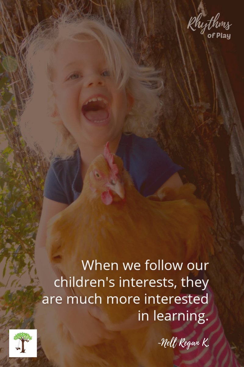 toddler holding a chicken with quote, "When we follow our children's interests, they are much more interested in learning." by Nell Regan K founder of Rhythms of Play