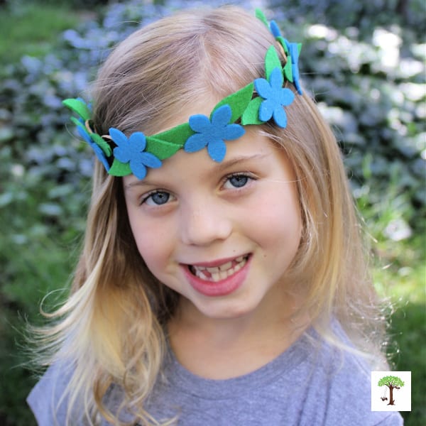DIY flower crown with blue felt flowers and green leaves (photo of Charlize Kartychok by Nell Regan Kartychok)