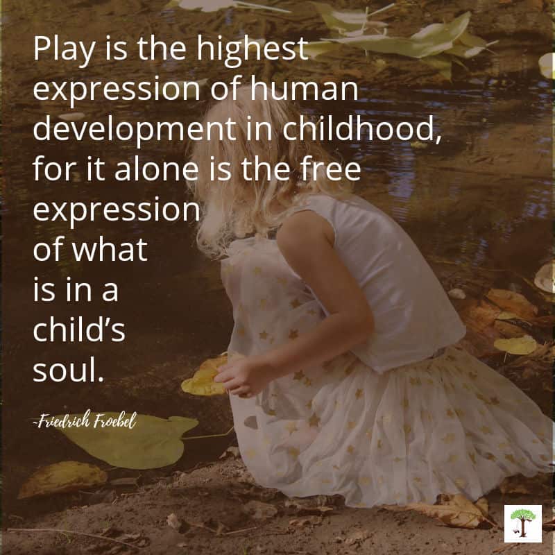 Kid playing with natural leaves; an open-ended material children can use for creative imaginative play.
