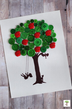 Button tree craft made to look like an apple tree made with red apple shaped and green round buttons.