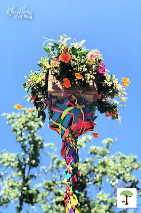 Maypole on May Day with gorgeous flower basket and ribbons at the top.