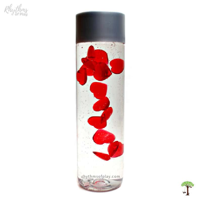 Slowly falling heart jar sensory tool and toy for children (or adults) of all ages made by Nell Regan Kartychok founder of Rhythms of Play.