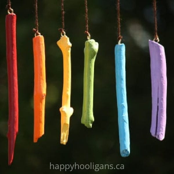 Rainbow wind chimes made with painted sticks by Happy Hooligans.