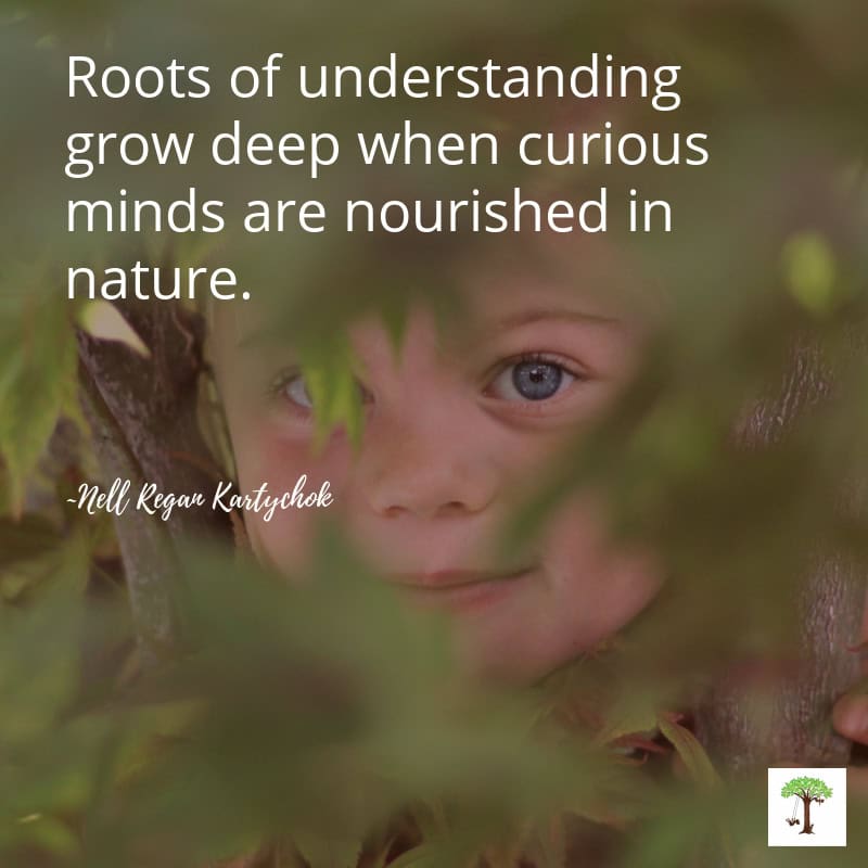 Charlize Kartychok playing in the limbs of a tree at three years old peeking out at the photographer Nell Regan Kartychok with her quote "Roots of understanding grow deep when curious minds are nourished in nature." by Nell Regan Kartychok